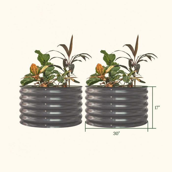Two dark grey 17"H x 30"W corrugated metal raised garden beds with plants.