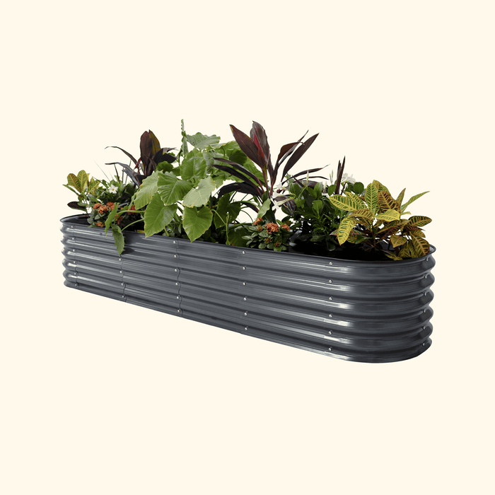 Corrugated dark gray metal raised garden bed with vibrant green, red, yellow, and orange plants. Ideal for outdoor container gardening.