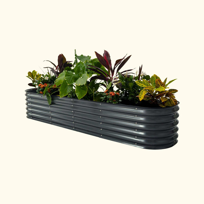 Dark grey corrugated metal raised garden bed with colorful plants and flowers.