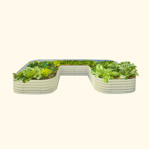Modular beige metal raised garden bed with various leafy green vegetables. Durable outdoor planter for backyard gardening.