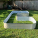 Beige corrugated steel L-shaped raised garden bed on green grass. Outdoor backyard planter.