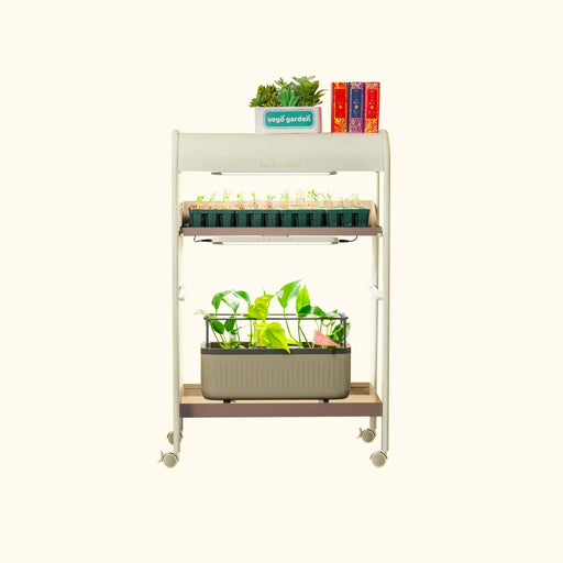 Vego Garden mobile grow cart with LED lights, cultivating seedlings & green plants on two tiers.