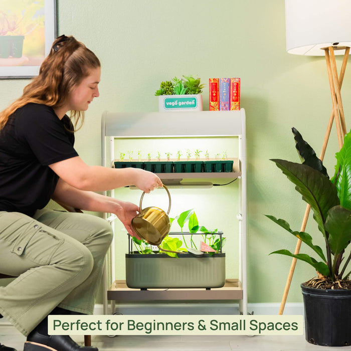Woman watering seedlings in a Vego Garden smart indoor grow system with LED lights. Ideal for beginners & small spaces.