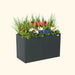 Vego Garden dark grey metal planter box filled with vibrant orange, white, blue flowers and lush green plants. Modern outdoor garden container.