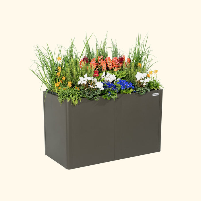 Vego Garden modern charcoal raised garden bed with vibrant mixed flowers: orange, red, white, and blue blooms.