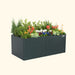 Modern charcoal planter box by Vego Garden, filled with colorful flowers, evergreen shrubs, and lush green plants.