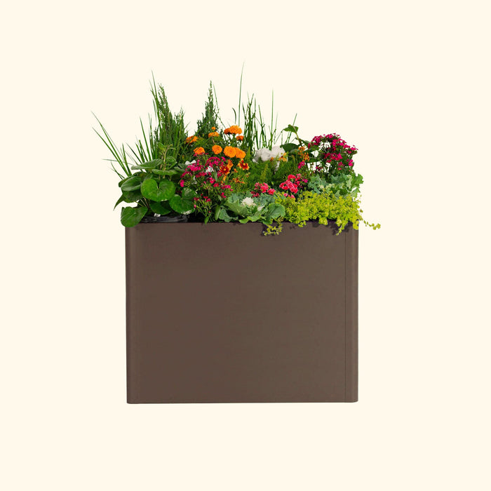 Dark brown rectangular garden planter box overflowing with diverse colorful flowers and lush green foliage.