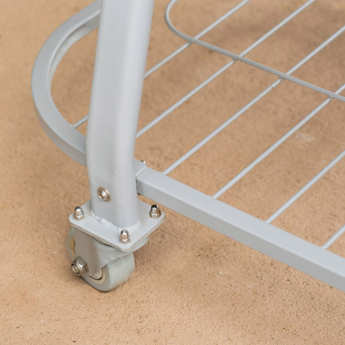 Grey metal rolling cart base featuring a smooth caster wheel, curved support leg, and wire grid shelf on a textured surface.
