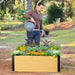 Happy man watering vibrant flowers and plants in a modern wood-look raised garden bed. Perfect for home gardening.