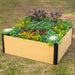 Light wood-grain composite raised garden bed with black corners, filled with colorful flowers, pansies, and kale.