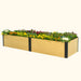 Long wooden raised garden bed with black metal accents, brimming with colorful pansies, flowers, and decorative kale.