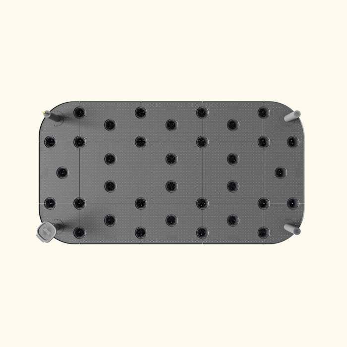 Top-down view: Modern grey modular platform with dotted grid, black circular inserts, and perforated cylindrical nozzles.