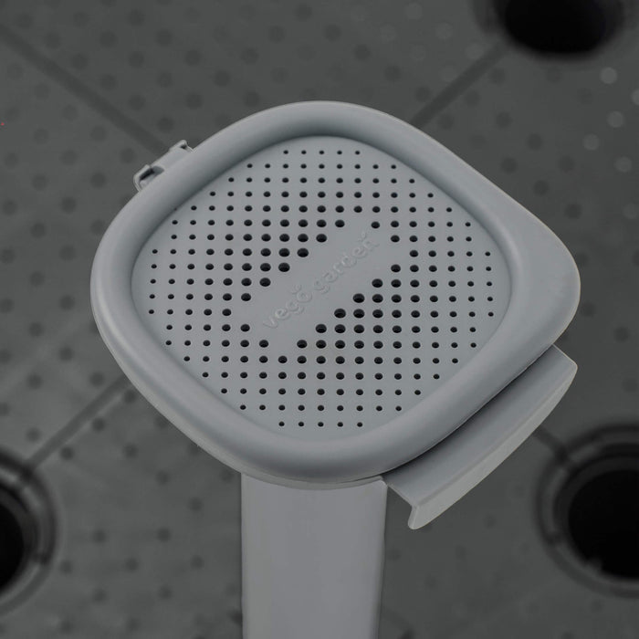 Vego Garden grey square perforated drainage screen for efficient water flow in raised garden beds and planters.