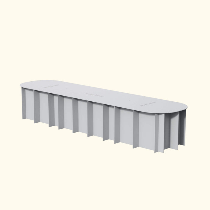 Light grey oval raised garden bed with corrugated sides and "veggie garden" text on top.