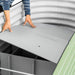 Installing a gray Veggie Garden base panel into a corrugated metal raised garden bed with internal sub-irrigation cells.