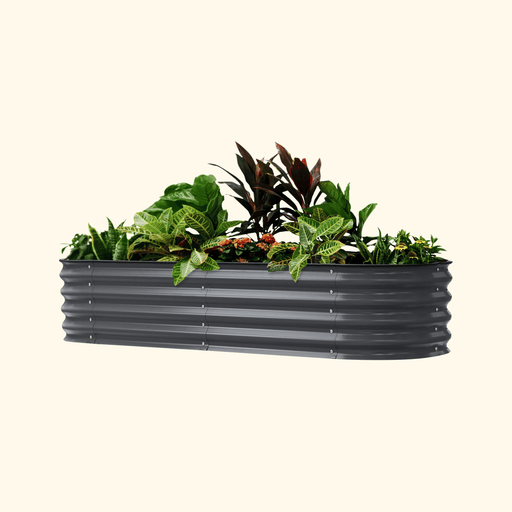 Dark gray corrugated metal raised garden bed planter filled with vibrant green plants, red foliage, and orange flowers.