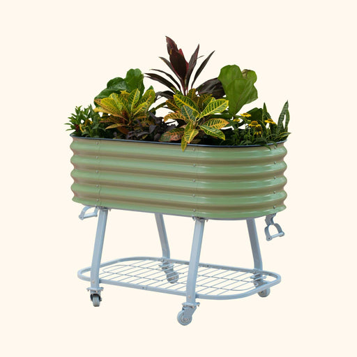 Green corrugated raised garden bed with colorful plants on a blue rolling stand and storage shelf.