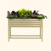 Beige corrugated metal raised garden bed with shelf, filled with kale, pink flowers, and ferns. Perfect for patio gardening.