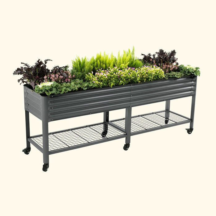 Mobile dark gray corrugated metal raised garden bed with mixed plants, lower shelf, and wheels. Patio vegetable planter.