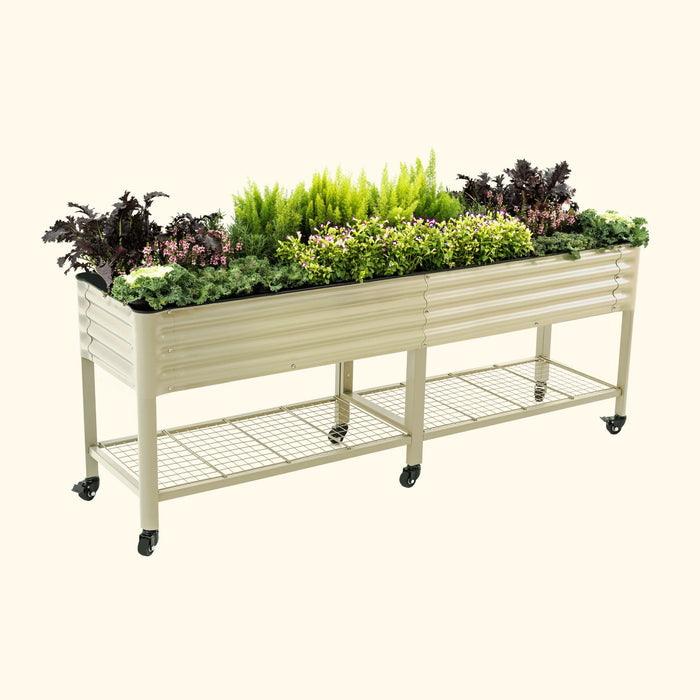 Beige corrugated metal raised garden bed on wheels with a bottom shelf, filled with vibrant flowers and fresh vegetables.