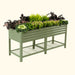 Sage green corrugated metal raised garden bed with flowers, leafy greens, and lower wire mesh shelf.