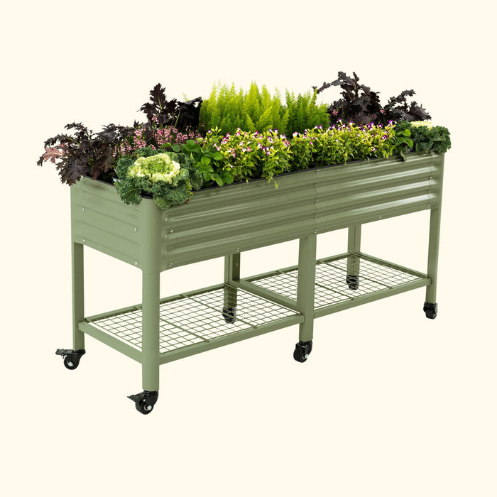 Sage green corrugated metal raised garden bed on wheels with a lower storage shelf, filled with various plants.