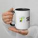 Person holding white two-tone mug with black handle, green sprouting seed logo, and 'SEED' text.
