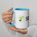 Person holding white coffee mug with blue handle and interior, featuring green sprout seed logo and 'SEED' text.