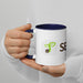 White and navy blue mug with green sprout seed logo and "SE" text, held by a person. Custom coffee cup.