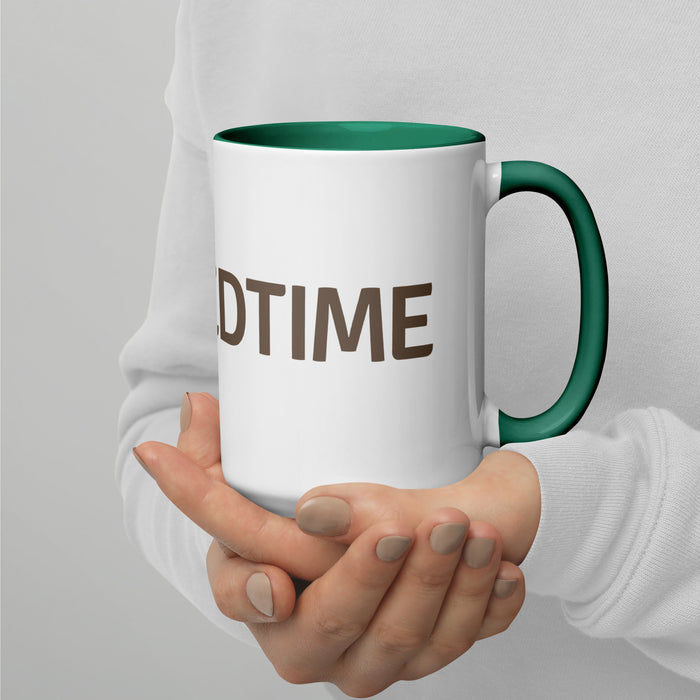 Person holding a white ceramic coffee mug with a green rim and handle, featuring partial text "DTIME". Custom drinkware gift.