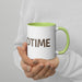 Hands hold white 'BEDTIME' mug with green rim and handle. Cozy coffee or tea cup.