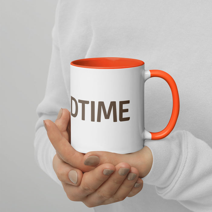 White ceramic coffee mug with orange handle & rim, featuring "DTIME" text. Held by hands in a white sweater.