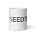White ceramic mug featuring brown "SEEDT" text and a green leaf logo.