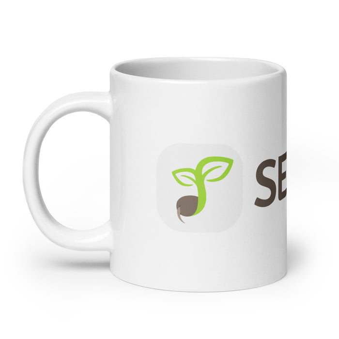 White coffee mug with green seed sprout logo and "SEED" text.