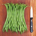 Fresh green beans and a sharp chef's knife on a rustic wood cutting board. Healthy vegetable cooking, meal prep.