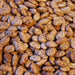 Close-up of speckled dry pinto beans. Healthy legumes, protein-rich ingredient for cooking, chili, and stews.