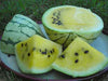 Fresh yellow watermelon: whole, half, and slices revealing sweet golden flesh with black seeds. Delicious summer fruit.