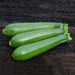 Three fresh green zucchinis on dark rustic wood. Healthy summer squash vegetables.