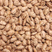 Dried pinto beans, speckled brown and beige. Versatile legumes for chili, refried beans, and hearty stews.