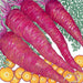 Vibrant purple carrots with green tops and sliced orange carrots, showcasing colorful root vegetables.