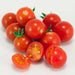 Vibrant red cherry tomatoes, whole and sliced. Fresh, ripe, and juicy for healthy recipes.
