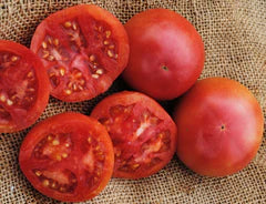 Fresh ripe red tomatoes, whole and sliced, with visible seeds on burlap. Healthy garden produce.