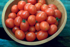 Bowl of fresh red grape tomatoes. Healthy, vibrant produce.